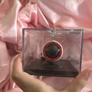 Red and Black Spherical Device in Display Case